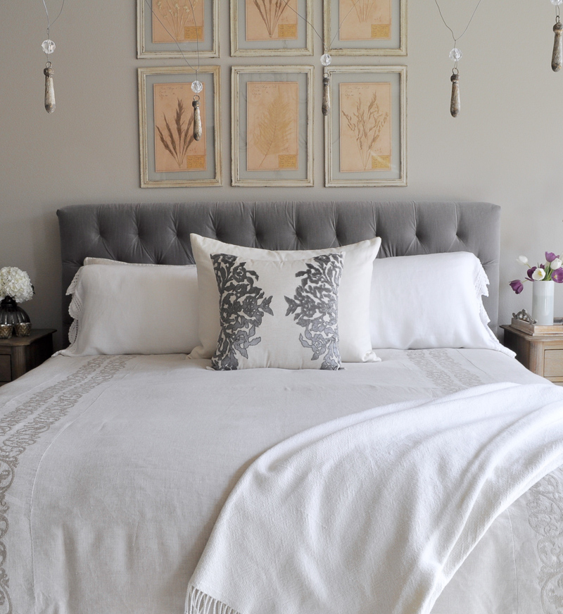 Bedroom Bed with Gray Fabric Tufted Headboard, Chandelier, Linen