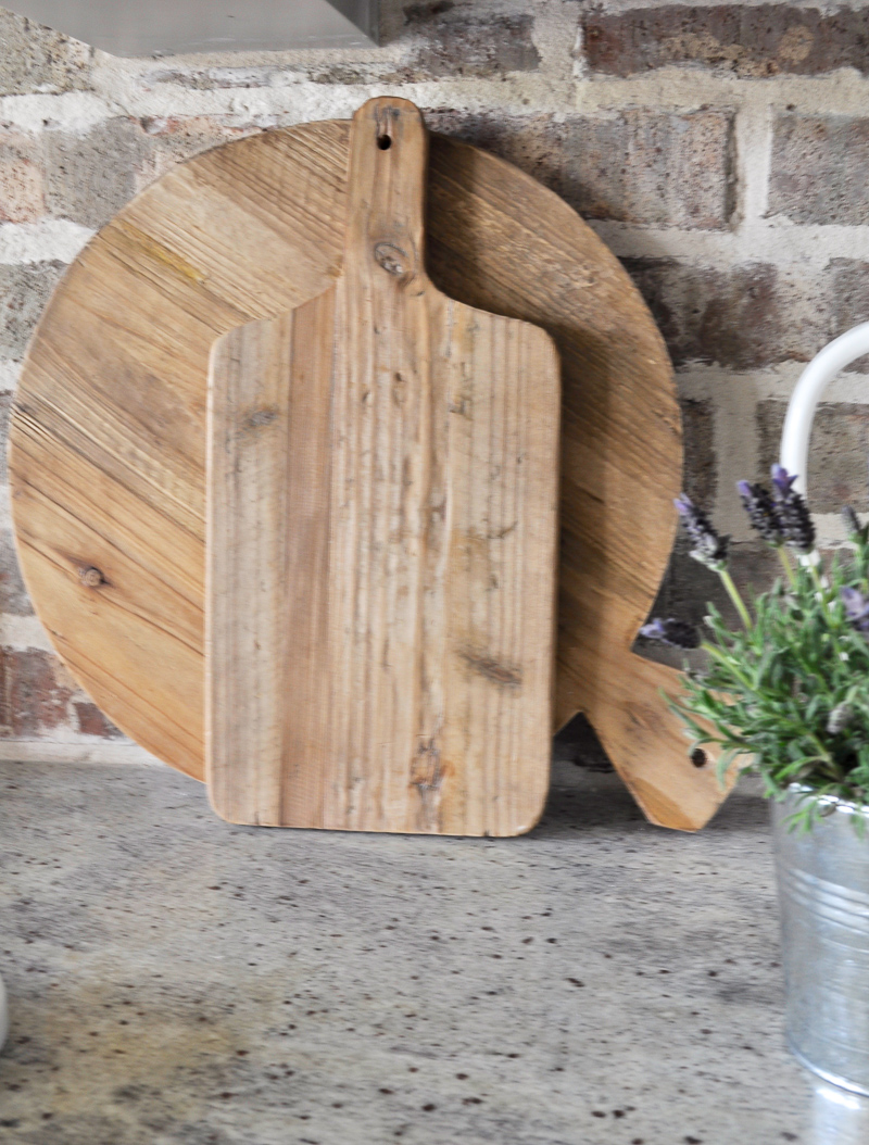 Kitchen Counters with Vintage Cutting Boards and A Brick Backspl