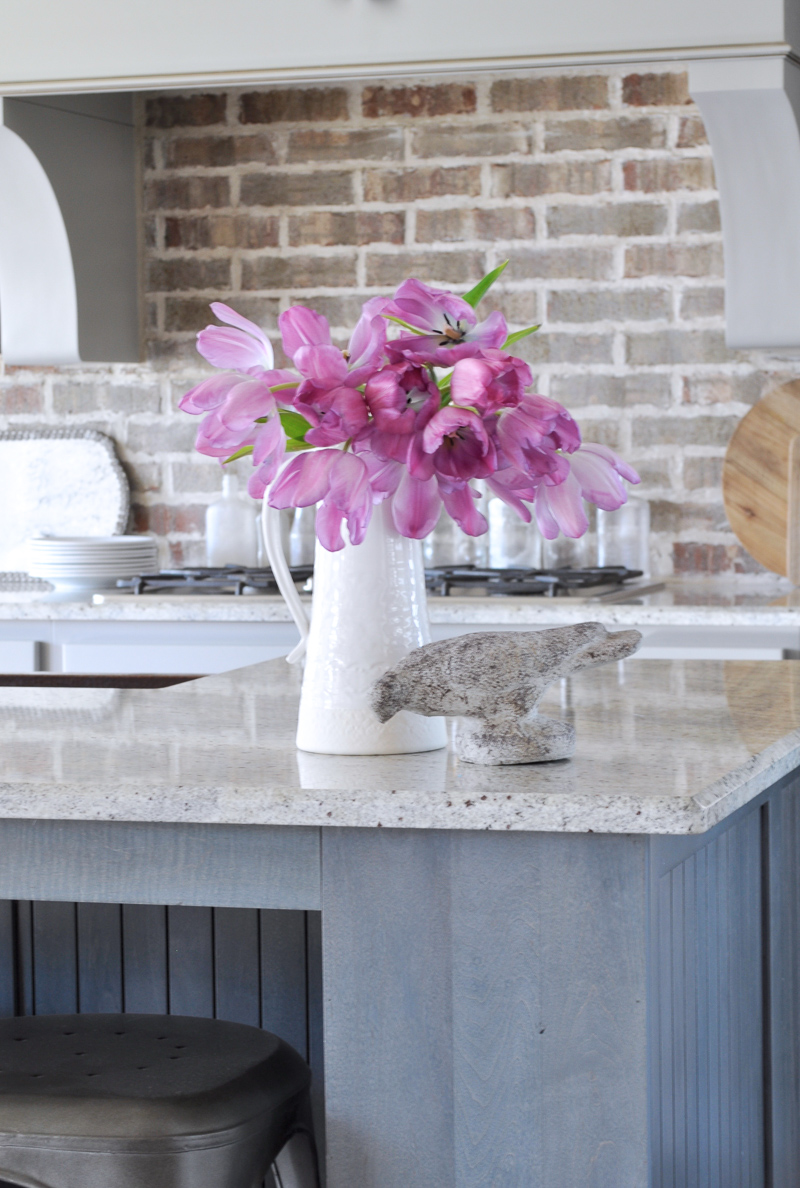 Pink Flowers in a White Pitcher Spring Decor Kitchen with Brick