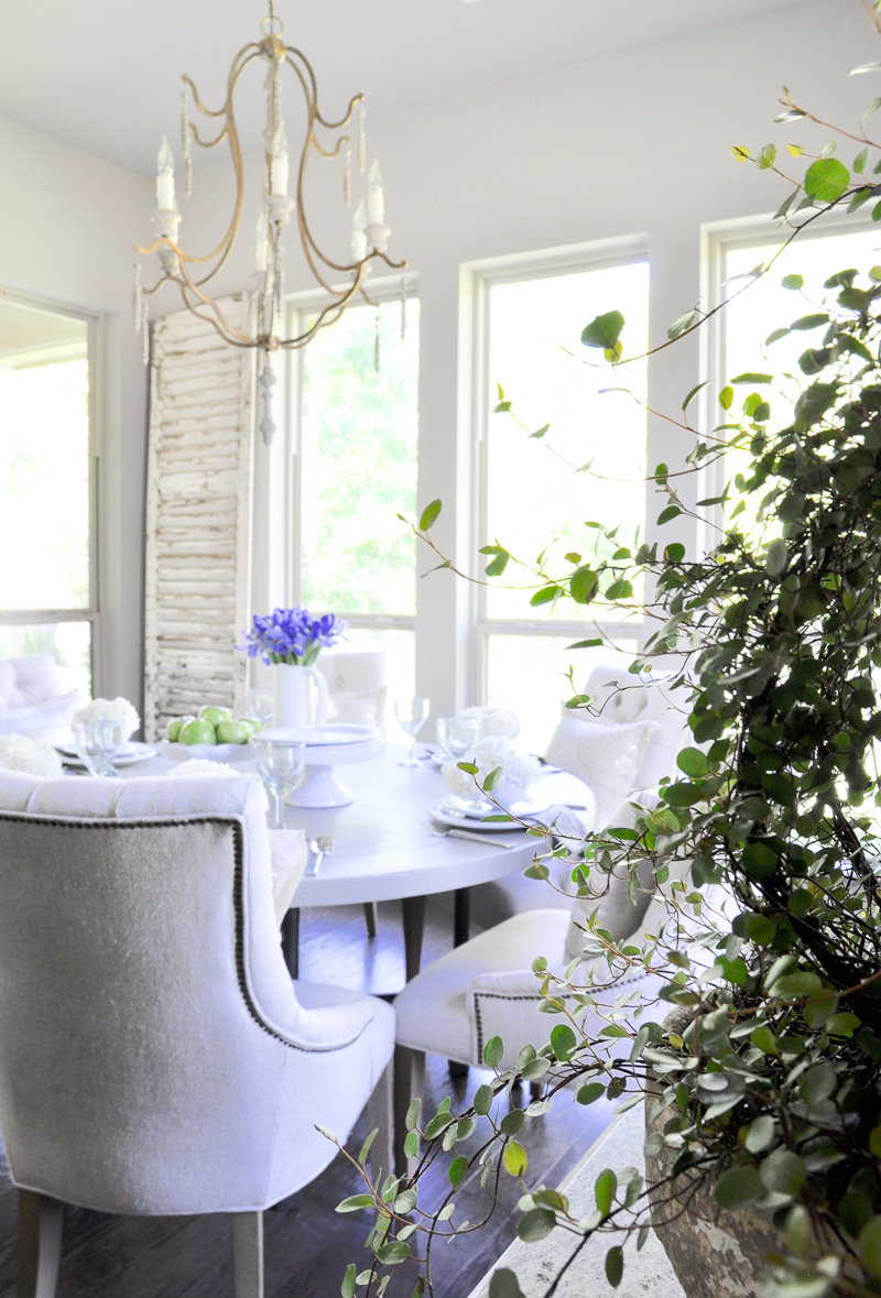 beautiful white dining room with spring flowers_