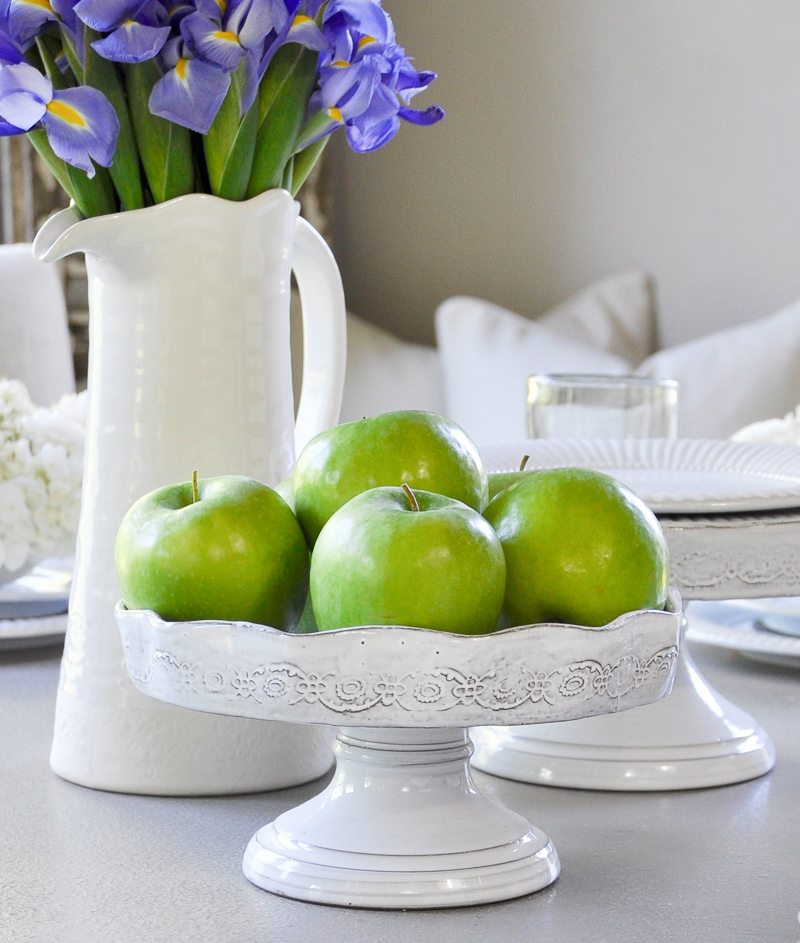 beautiful white tablescape with green apple on cake stands