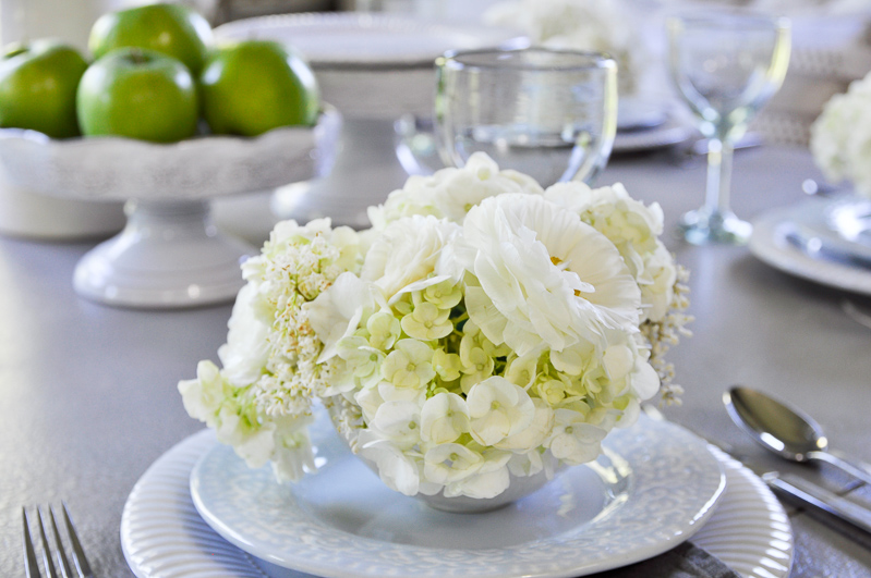 gorgeous white tablescape for spring with white flowers and green apples_