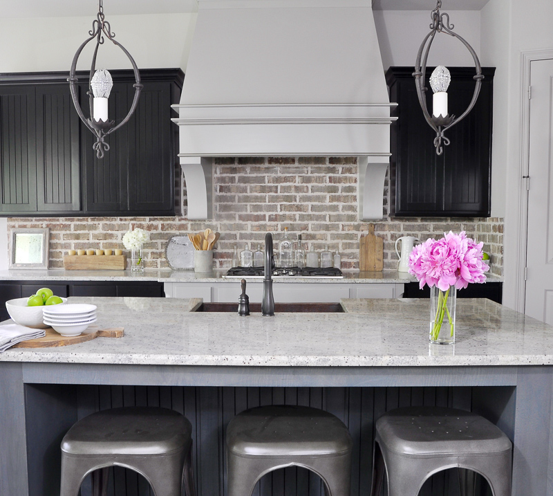 Beautiful Kitchen with Brick Backsplash and Industrial Stools