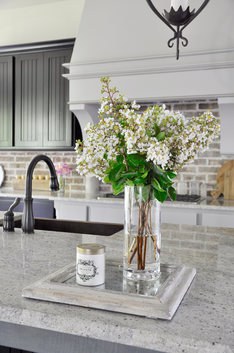 Beautiful tray with vase and candle used as kitchen decor