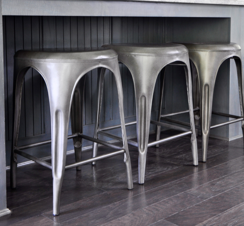 Gunmetal bar stools in kitchen with blue gray cabinets