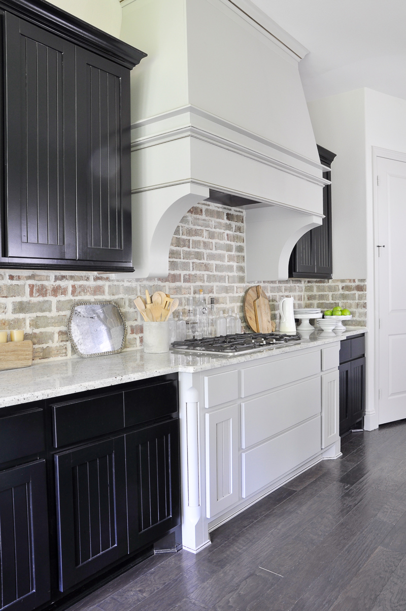 Industrial Kitchen Brick Backsplash and Large Venthood