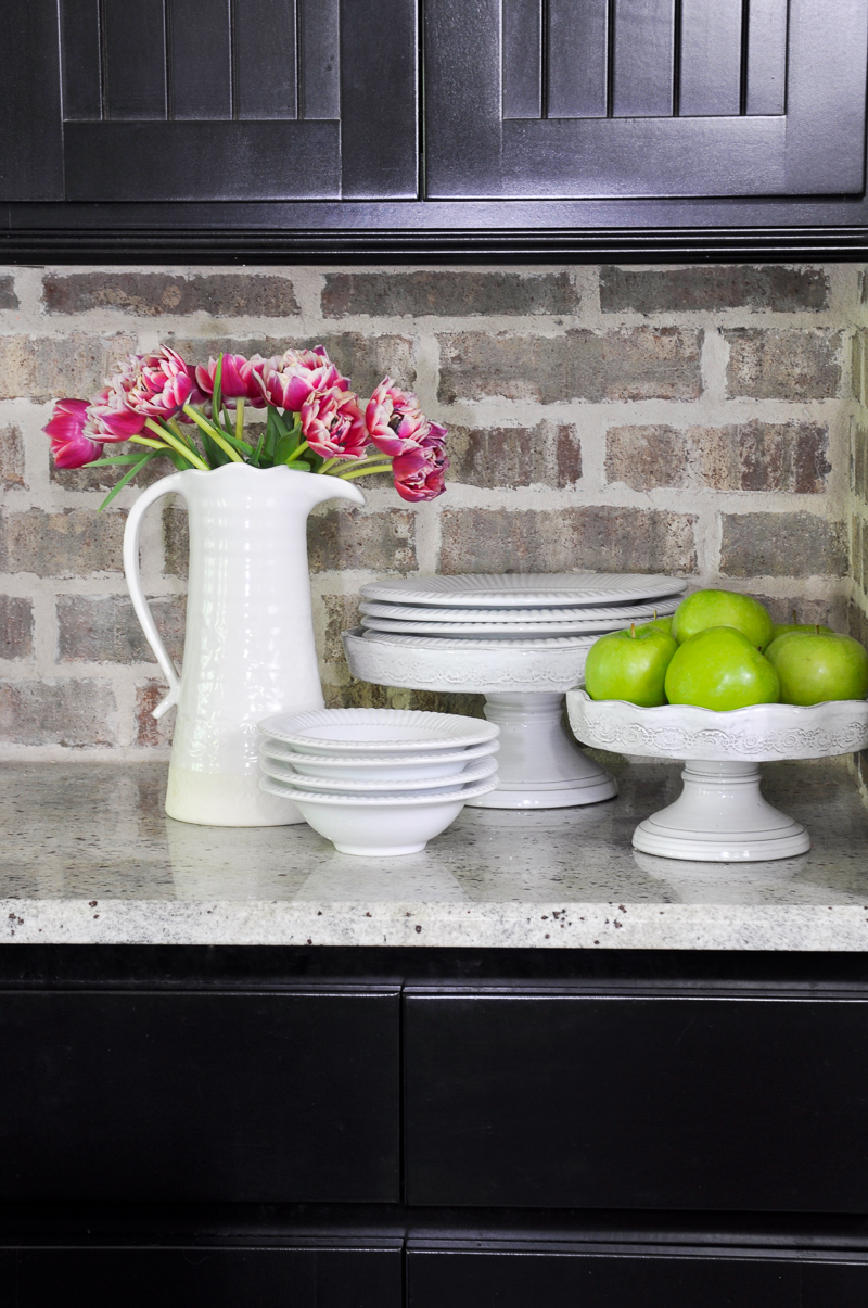 Industrial Kitchen Brick Backsplash and White Pottery Accessories