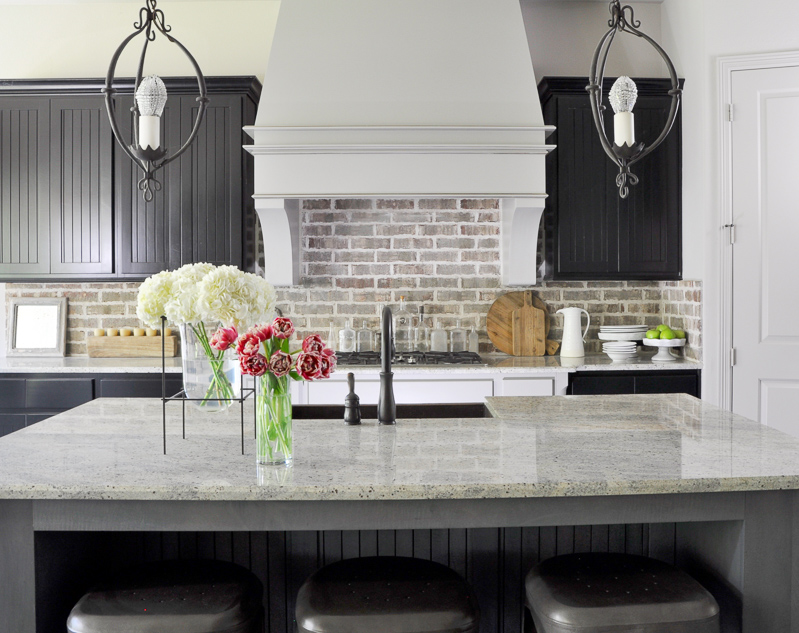 Industrial Kitchen with Brick Backsplash and Statement Venthood_