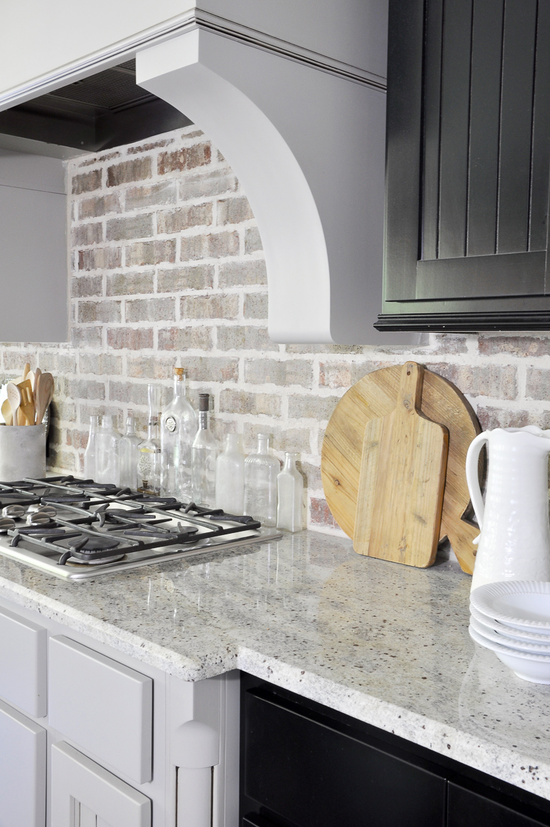 Kitchen with Statement Vent Hood and Black Cabinets-3