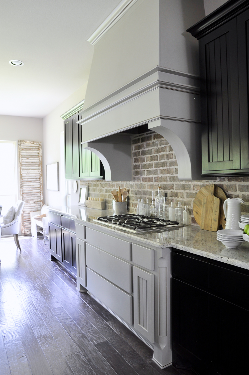 Kitchen with Statement Vent Hood and Black Cabinets-4