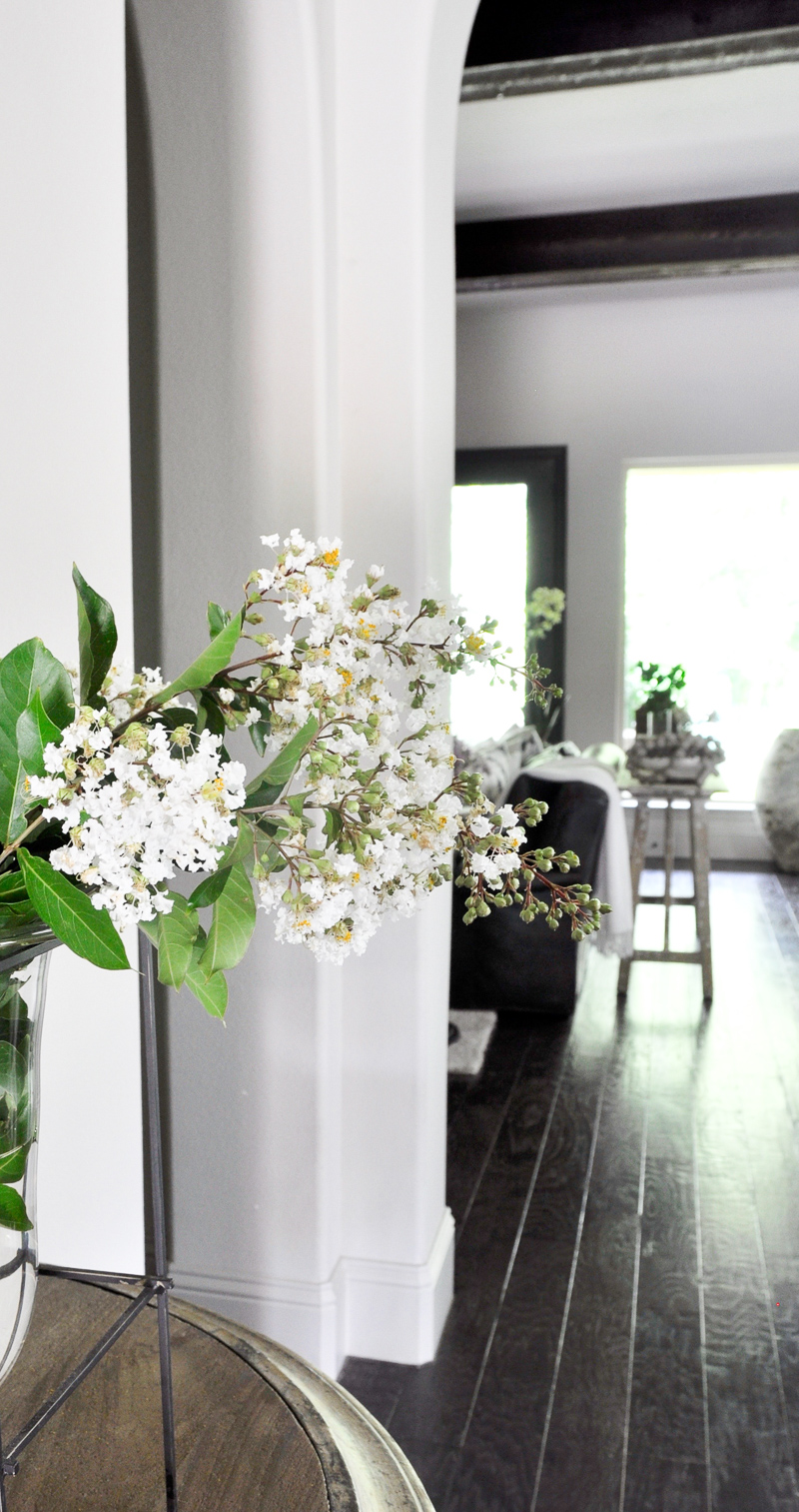 Stunning Foyer with Arches Beams and White Summer Flowers_