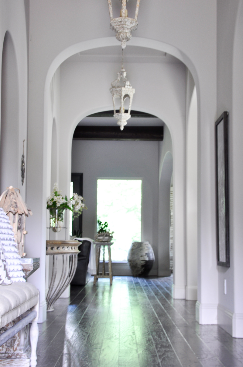 Stunning Summer Entry Hall with Arches Pendant Lights and Beams