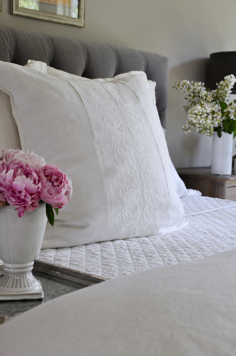 White linen bedding with embroidered sham so gorgeous