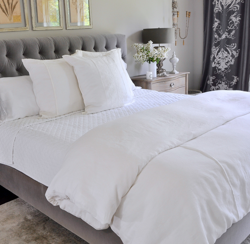 beautiful all white summer bedding in gray and white room