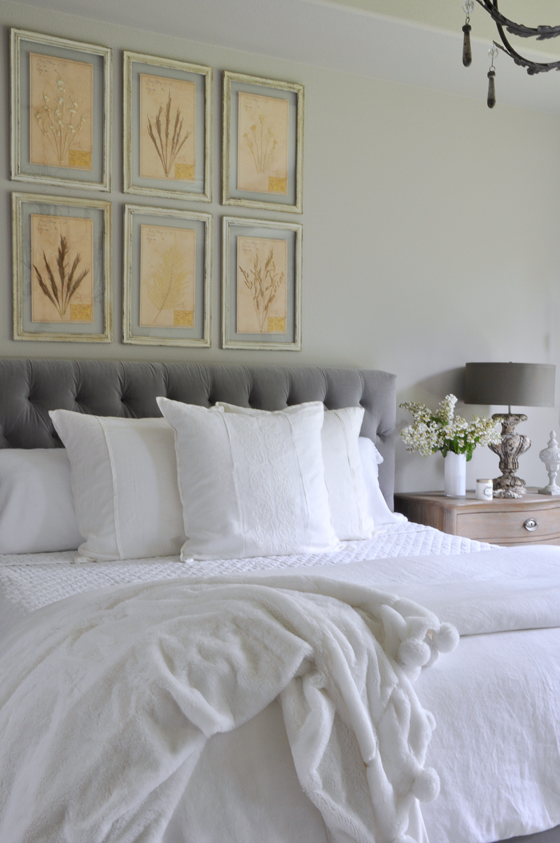 992 bedroom with botanicals above bed white layered linen and po