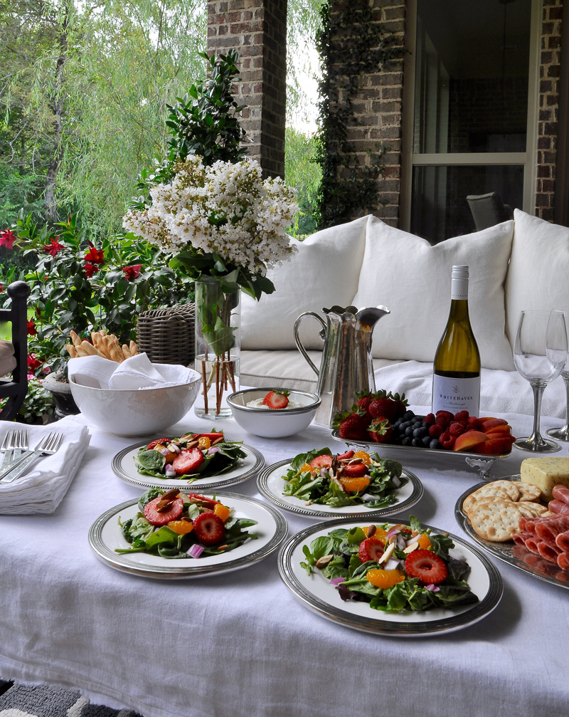 Summer outdoor patio party with flowers white linens and beautiful white and pewter dishes-2