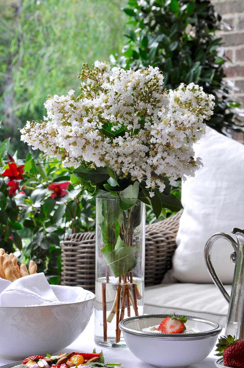 Summer outdoor patio party with flowers white linens and beautiful white and pewter dishes-4