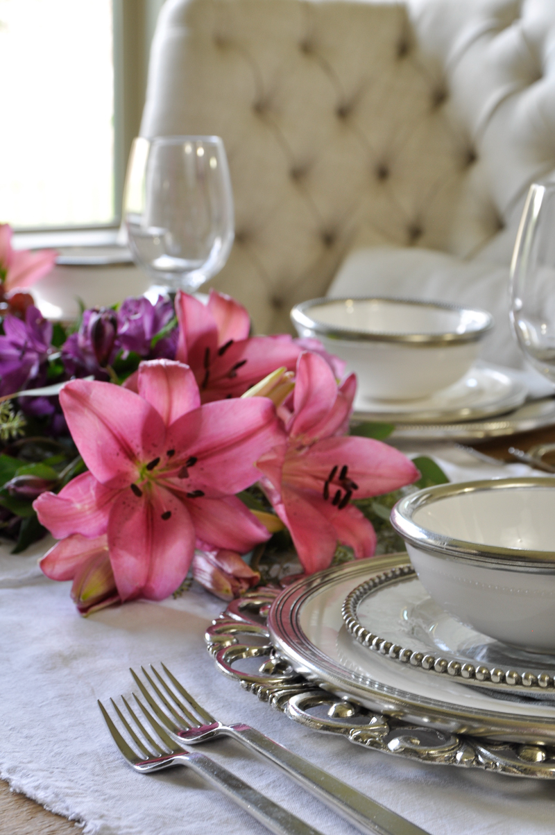 beautiful table set with white ceramic and pewter in layers by arte italica_