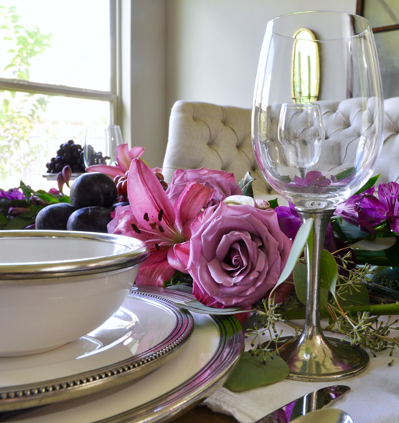 pewtered rimmed dishes and wine glasses add elegance to dining table