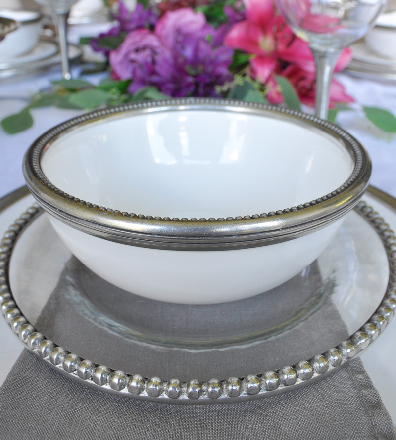 pretty glass and ceramic dishes with pewter rims and matching wine glasses_