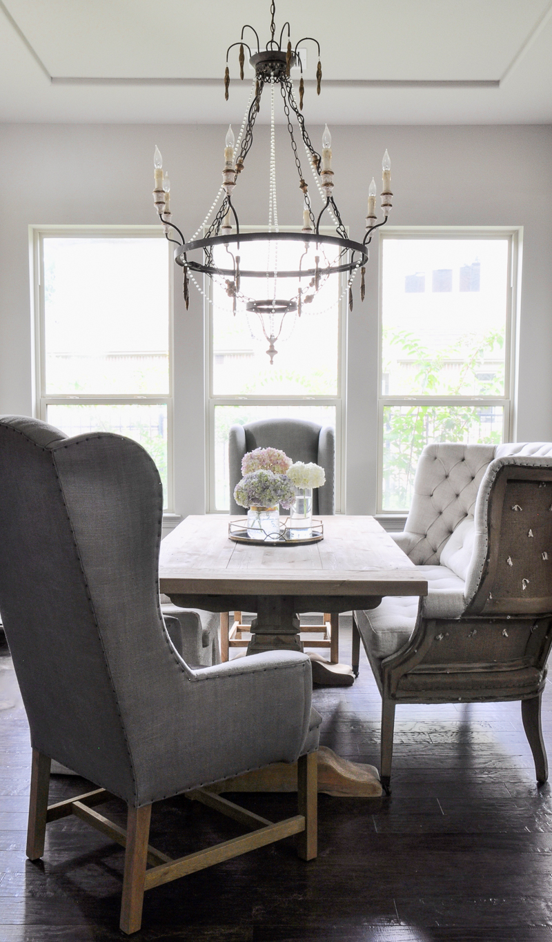 Elegant dining room with restoration hardware furniture and beautiful chandelier