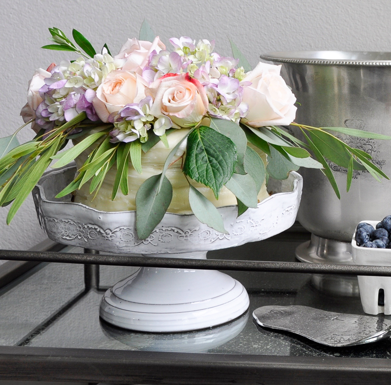 bar cart styled with a decorated cake