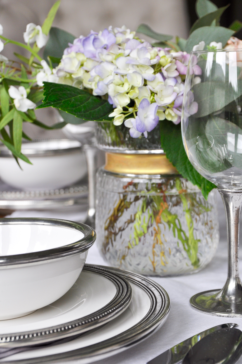 beautiful table pewter rimmed dishes and flowers