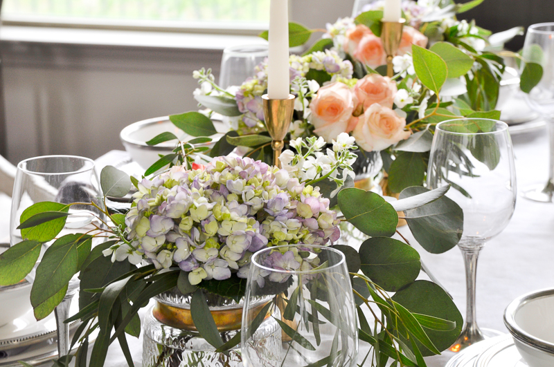 beautiful tablescape row of flowers in gold rimmed vases