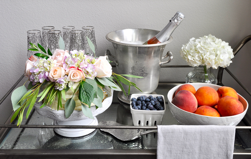 beautifully styled champagne and cake bar cart_