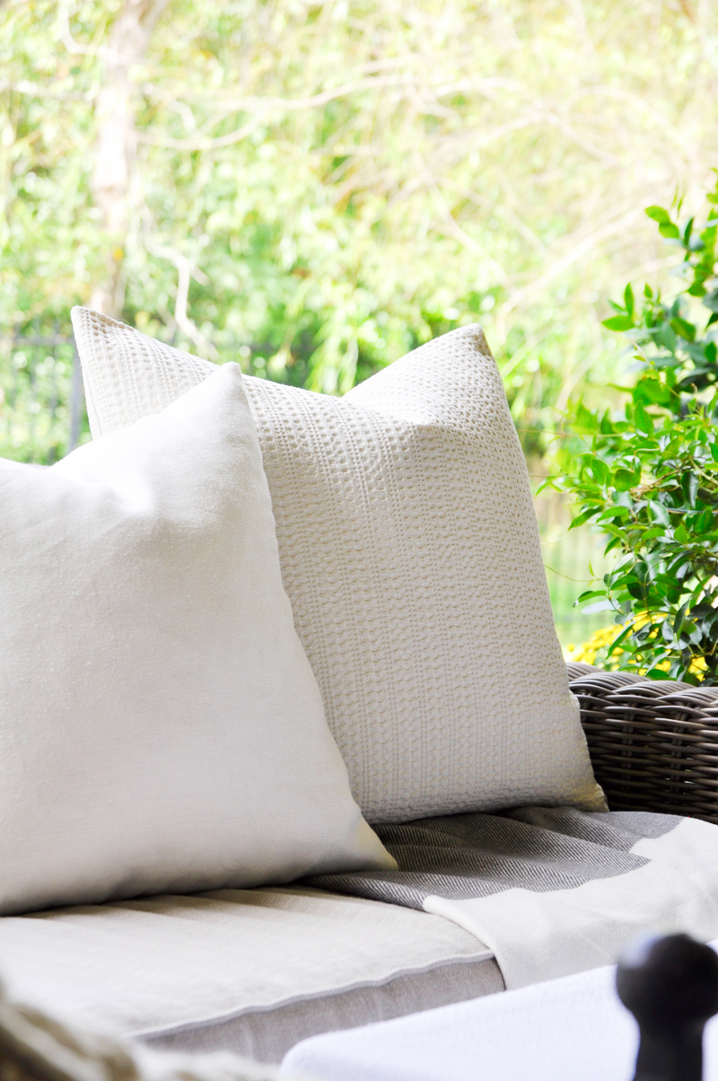 beautiful-outdoor-couch-with-white-pillows_