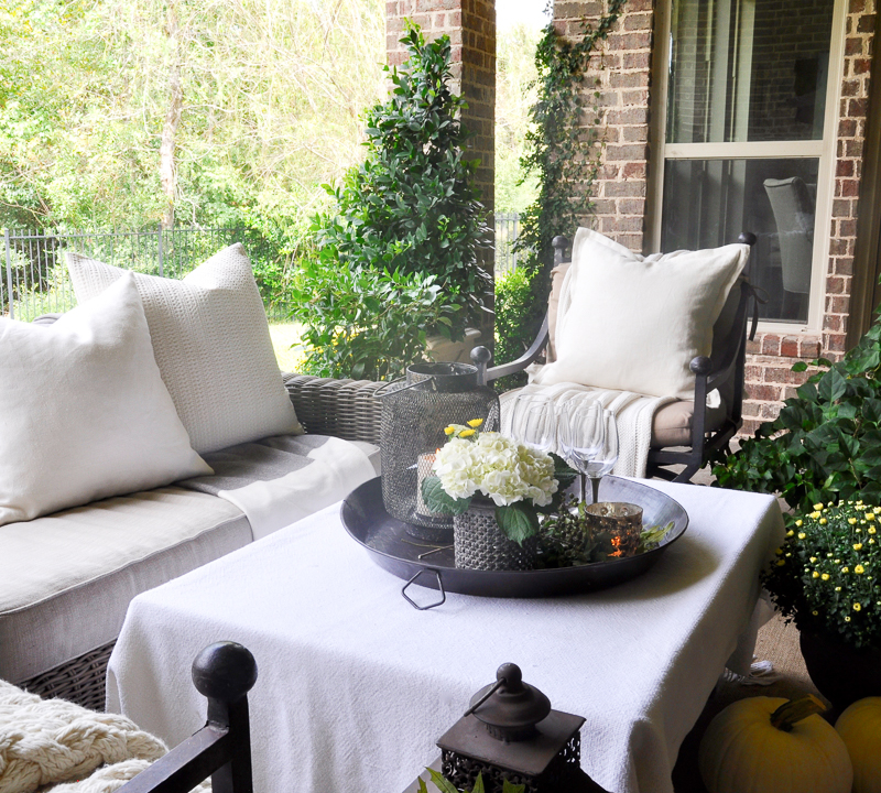 beautiful-outdoor-living-area-decorated-for-fall-with-cream-and-white
