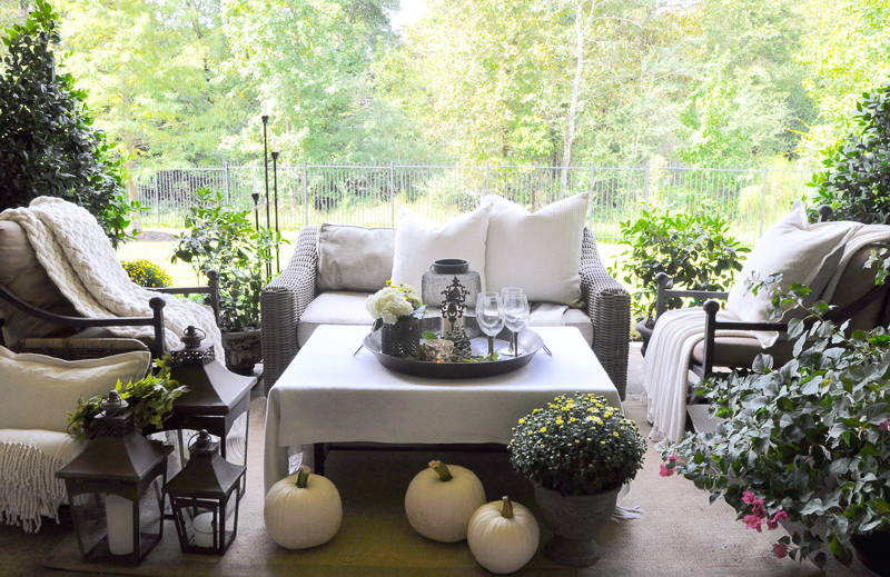 beautiful-outdoor-living-area-decorated-for-fall-with-white-pumkins_