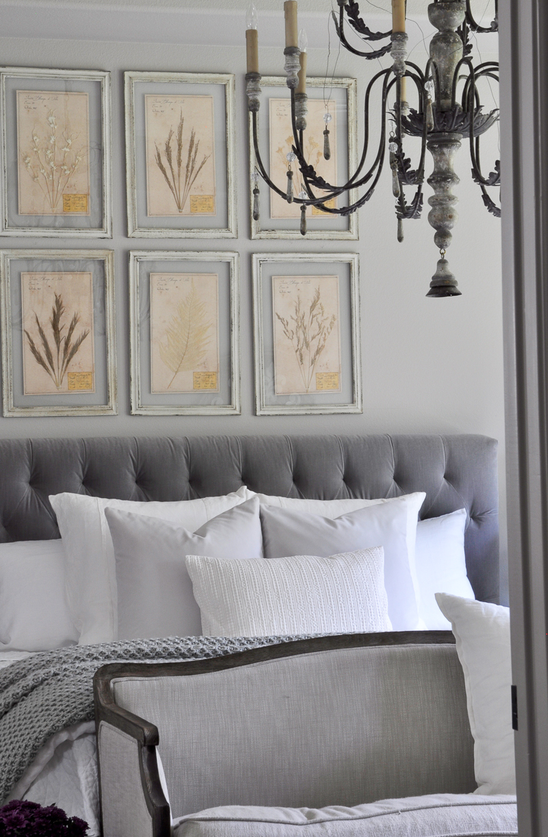 beautiful-gray-and-white-bedroom-with-large-chandelier-and-tufted-headboard