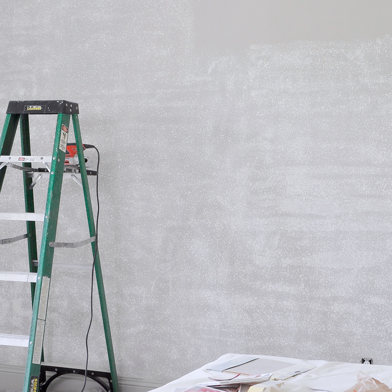 using-a-hand-sander-to-sand-texture-off-walls-for-wallpaper-installation