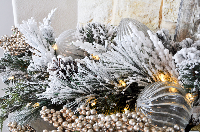 christmas-ornaments-added-to-garland-on-mantle_