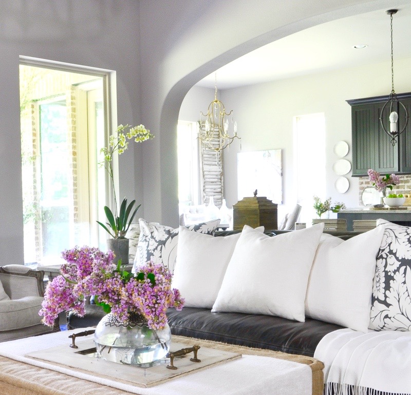 beautiful-white-accents-in-family-room-ottoman-with-vase-full-of-crepe-myrtle-clippings_