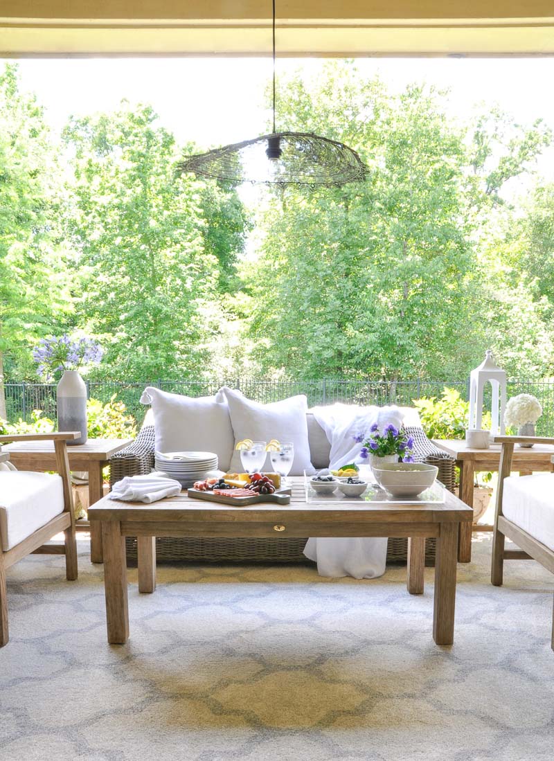 Beautiful outdoor space teak furnishings white pillows