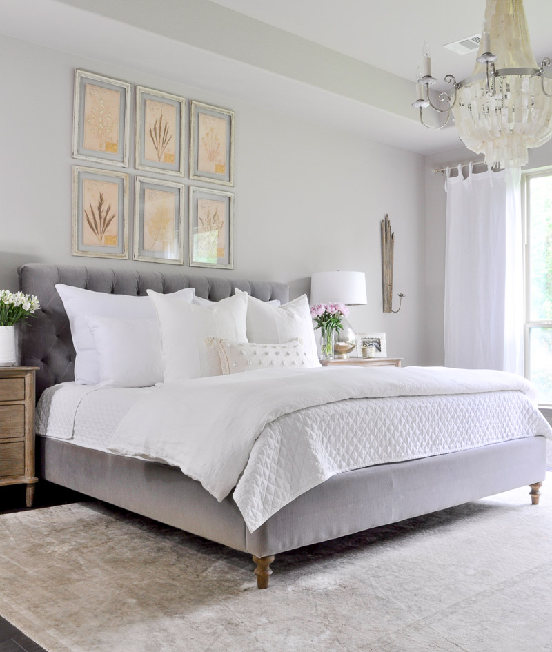 Beautiful gray bed with white bedding 