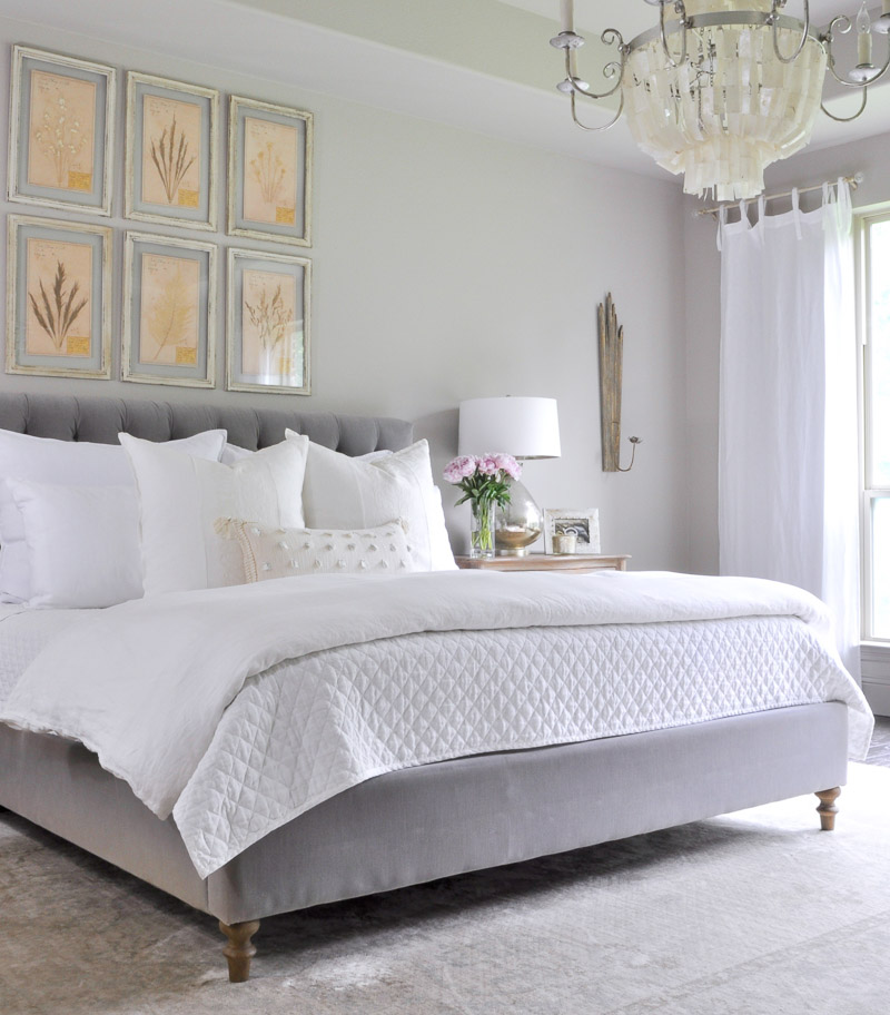 Beautiful gray and white bedroom with statement chandelier 