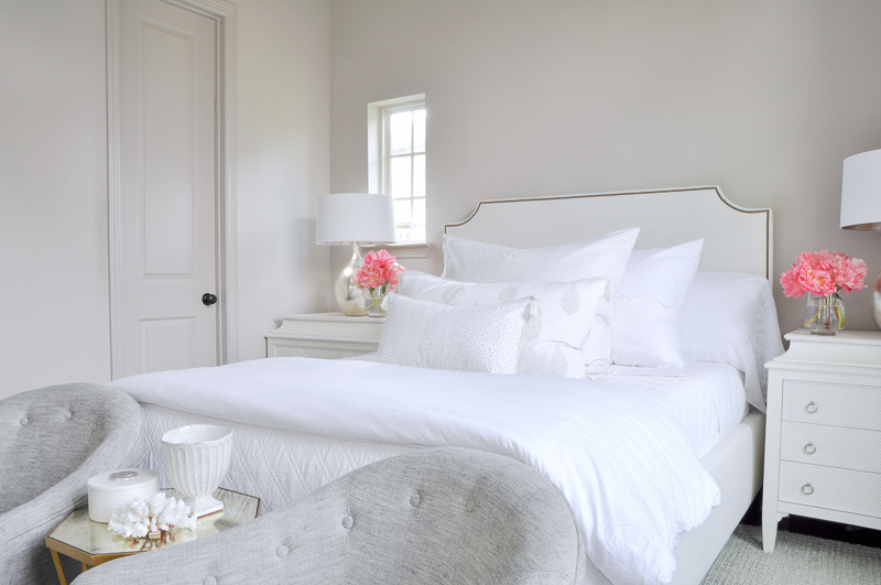 white bedding with colorful pillows