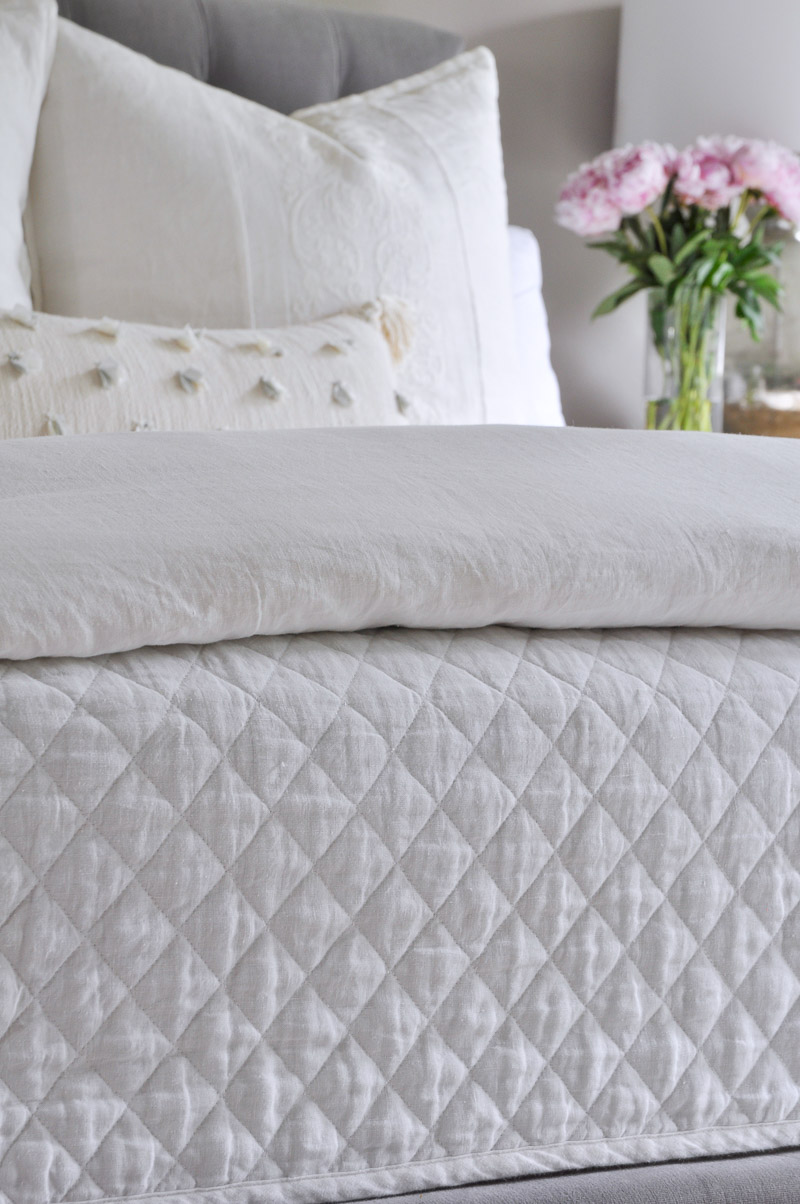 Gorgeous linen bedding in white and gray bedroom 