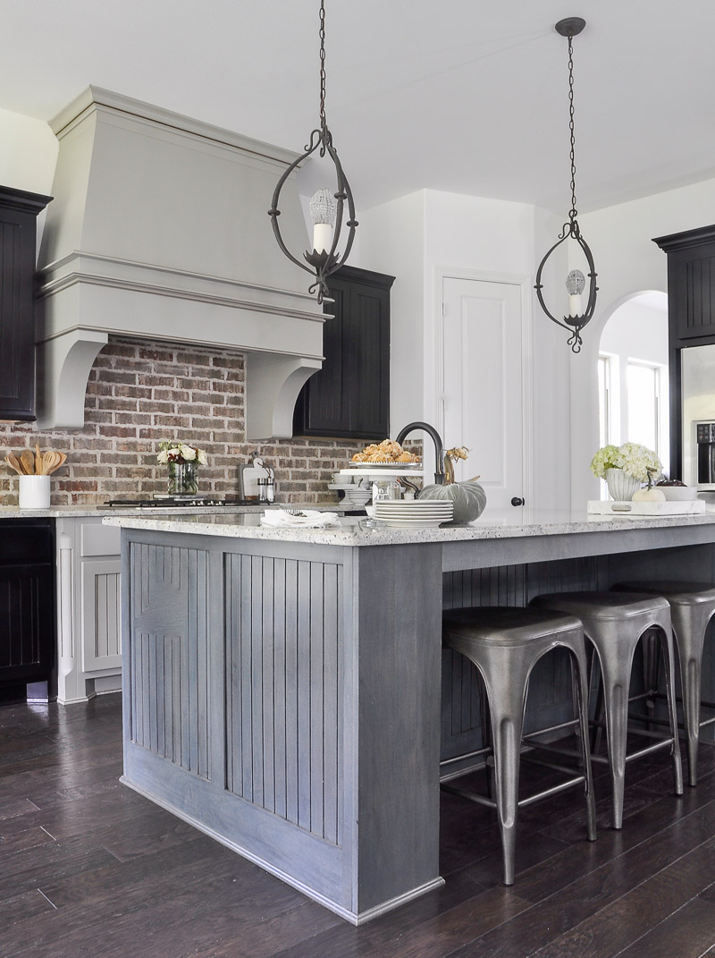 beautiful kitchen with brick backsplash