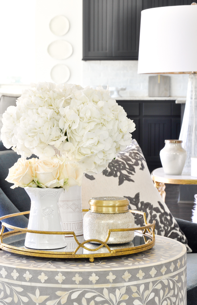 round end table gold tray white vases