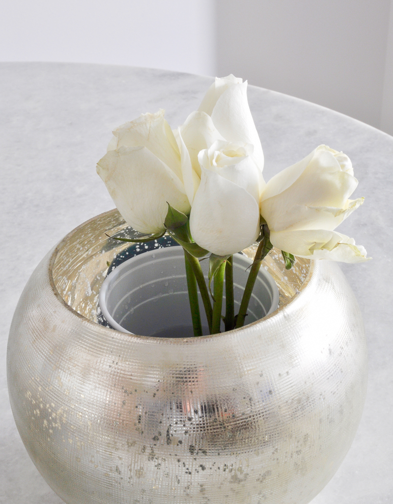 arranging rose in a round vase