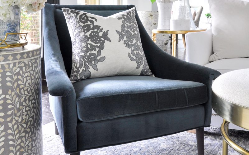 beautiful living room with blue velvet chair