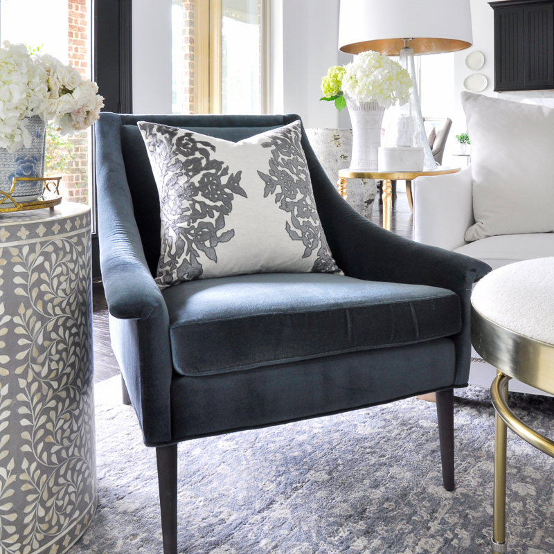 beautiful living room with blue velvet chair