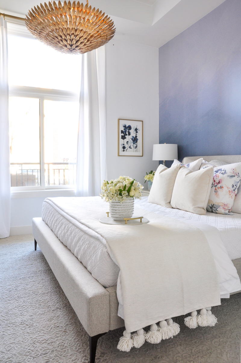 beautiful bright spring bedroom with white and floral bedding