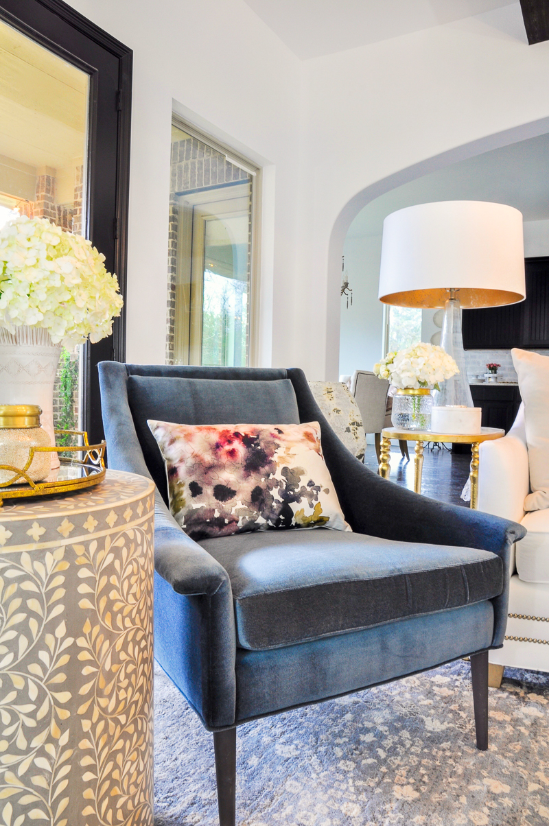 blue velvet chair and floral pillow