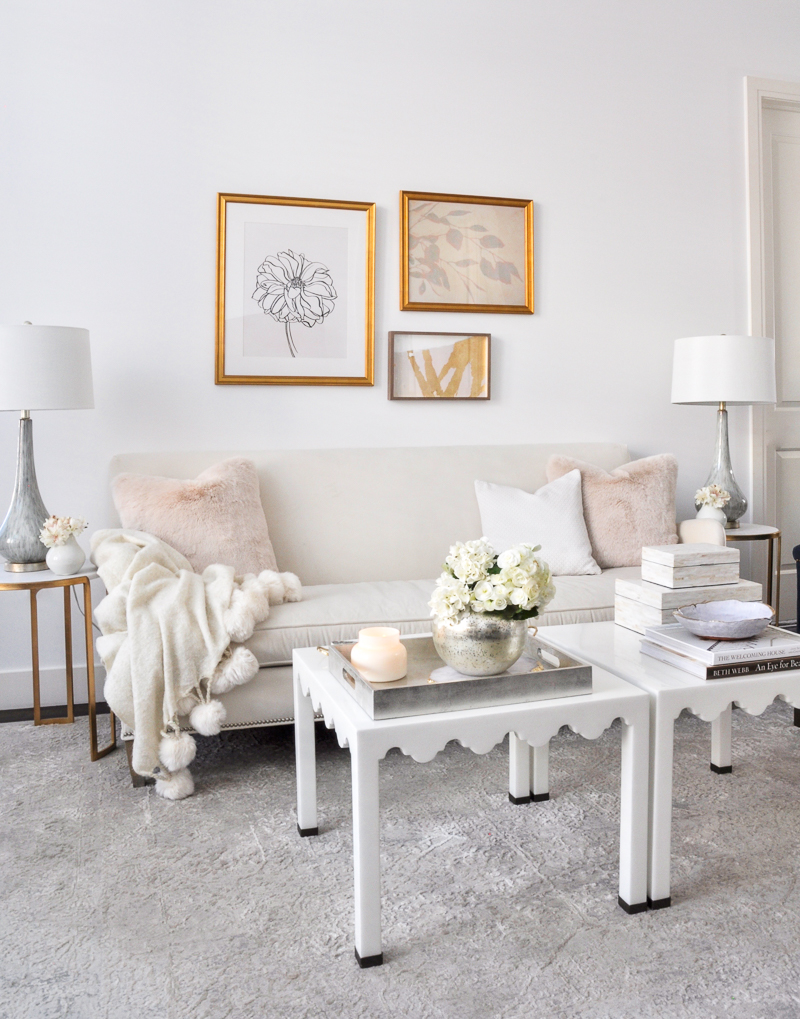 elegant white living room with blush pillows