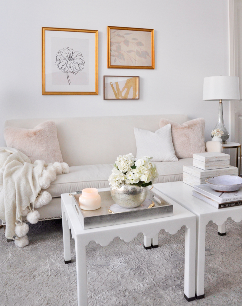 elegant white living room with spring decor in blush and gold accents 